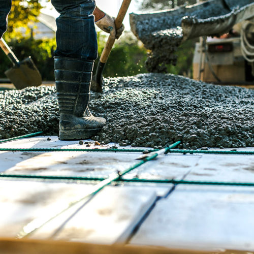 contractors close up working on a concrete slab at commercial property blue ridge mo